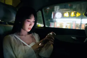 A concerned woman looking at her phone during a rideshare.