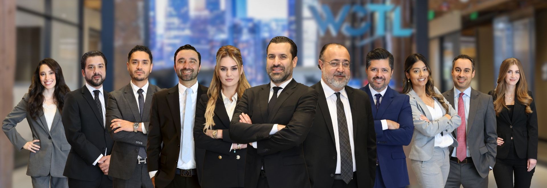 A row of WCTL attorneys with the lobby in the background.
