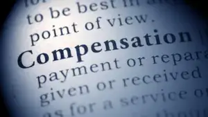 A dictionary with the word "compensation" bolded and focused on.