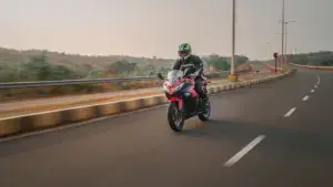 A motorcycle rider driving on a empty freeway.