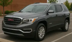 A gray GMC Acadia parked in a lot.